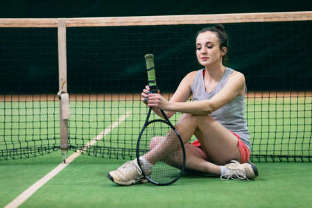 Tennis woman player portrait with racket and ball at court.の写真素材