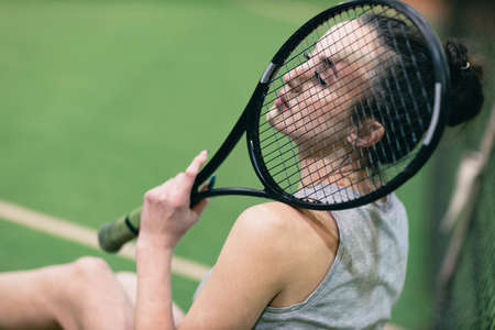 Tennis woman player portrait with racket and ball at court.の写真素材
