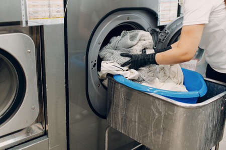 Dry cleaning put in washing machine clothes. Clean cloth chemical process. Laundry industrial dry-cleaning.の写真素材