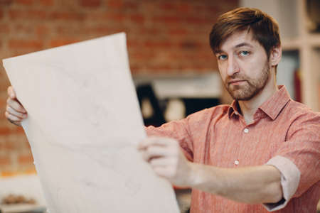 Architect with blueprints and layout design project at office bureau