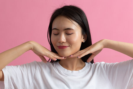 Close up portrait of young asian japanese woman doing facebuilding yoga face gymnastics yoga...