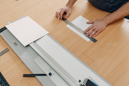 Framing Workshop cutting cardboard carton frame. Making baguette handmade picture frame at studio.