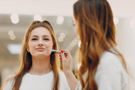 Beautiful young woman applying makeup beauty visage brush.の写真素材