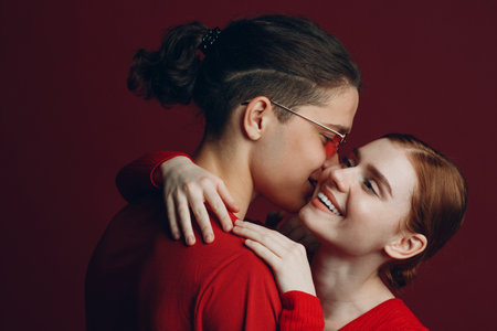 Beautiful young couple hugging on red background. Valentines day