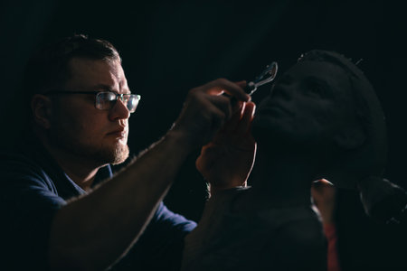 Man sculptor creates sculpt bust clay human woman sculpture. Statue craft creation workshop.