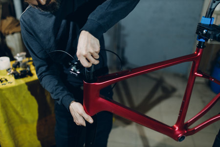 Mechanic repairman assembling custom bicycle spacer intermediate ring in workshop