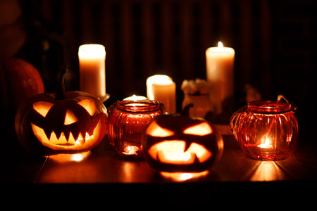 Making Halloween pumpkin Jack-o-lantern. Pumkins and candles on table.の写真素材