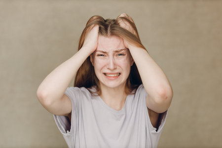 Portrait of young caucasian actress crying upset woman against beige background. Acting test Casting film movie acting auditions.の写真素材
