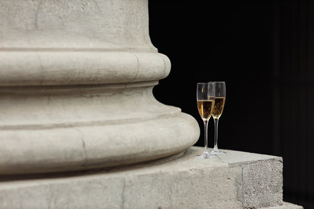 Two glasses of champagne at column city street outdoor.の写真素材