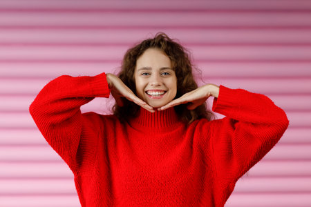 Young red haired woman doing face yoga facial gymnastics self massage and face building exerciseの写真素材