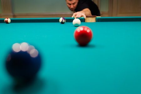Billiard player at billard table or snooker american billiards pool sport game