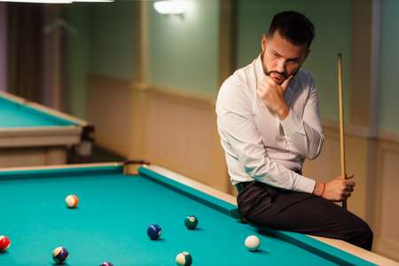 Billiard player at billard table or snooker american billiards pool sport gameの写真素材