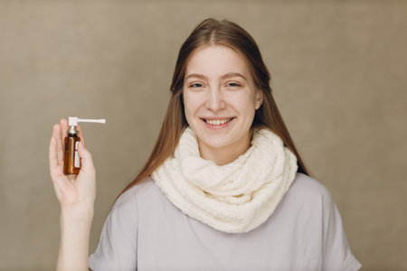 Young woman has flu catarrh ill sick disease treatment cold hold medicine nasal sprayの写真素材