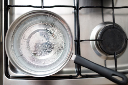 Saucepan stainless steel with boiling water on a gas stove.の写真素材