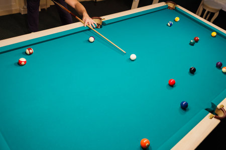 Billiard player at billiard table or snooker american billiards pool sport game