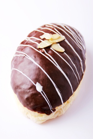 Delicious bread topped with chocolate, white sauce, and pine nutの写真素材