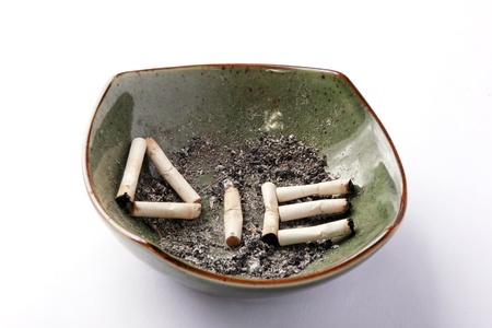 Die written on a dirty ashtray with cigarettesの写真素材