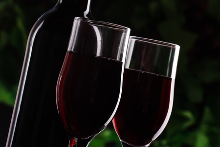 Red wine in a glass of grape background in decorative lightingの写真素材