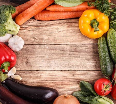 Vegetables on wood background with space for text. Organic food.の写真素材