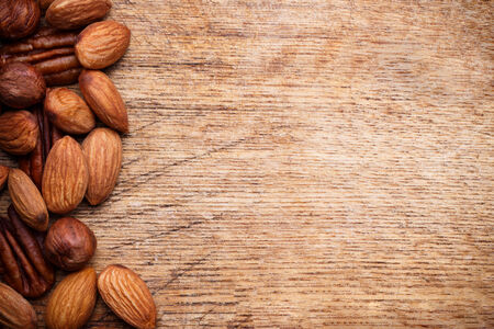 Background texture of assorted mixed nuts including cashew nuts, pecan nuts, almonds