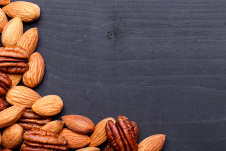 Background texture of assorted mixed nuts including cashew nuts, pecan nuts, almondsの写真素材