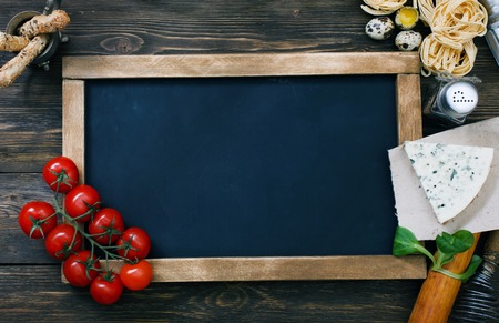 Italian food on vintage wood background, with chalkboard, with copyspaceの写真素材