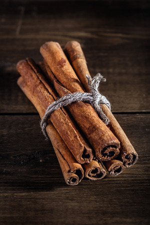 Cinnamon on the wooden background.の写真素材