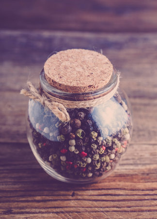 Vintage jar with spices on a wooden background. Close-up.の写真素材