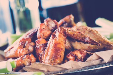 Roasted wings on the plate with sauce close-upの写真素材