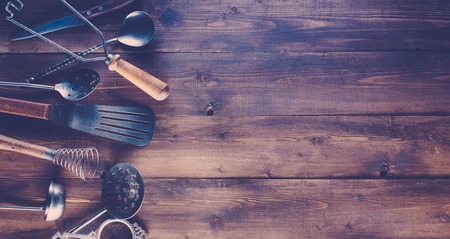 Vintage kitchen items on old wooden background.の写真素材