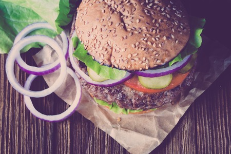 Classic Burger on wooden background. Vintage style.の写真素材