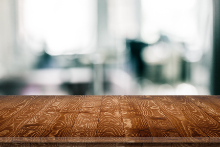 Empty wooden table for product placement or montage with focus to table top in the foreground, with white background. Wooden board empty table perspective.の写真素材