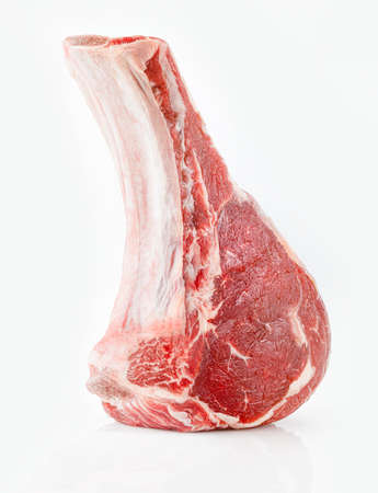 Raw bone-steak. Cowboy or tomahawk steak isolated on white backgroundの写真素材
