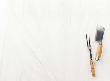 Butcher cutlery over light background. Vintage knife nd fork on table with copy spaceの写真素材