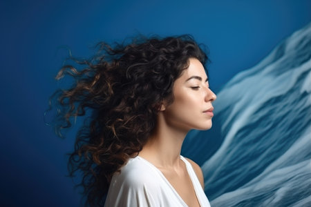 wave, portrait and woman in studio for freedom on a blue background for empowermentの素材