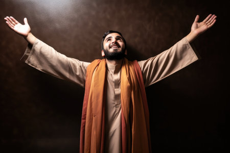 shot of a muslim man standing with his arms outstretchedの素材