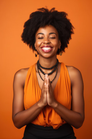 portrait, black woman in studio and happy face with zen, peace or relax on orange backgroundの素材