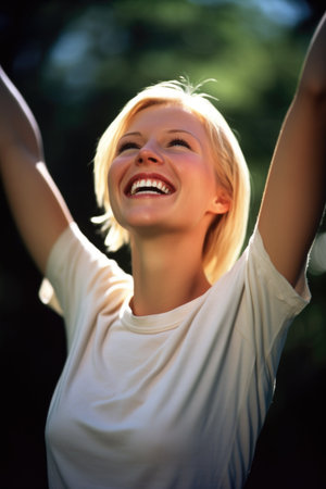 portrait of a female smiling happily with her arms raisedの素材