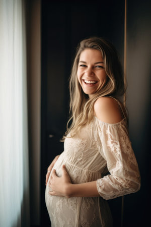 shot of a pregnant young woman holding her baby bump and smiling happilyの素材