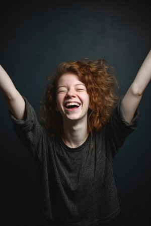 portrait of a smiling young woman with her arms raisedの素材