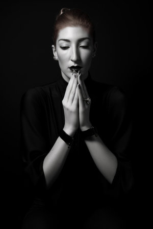 all black, white and hands portrait of a model in the studio for a fashion editorial mock upの素材