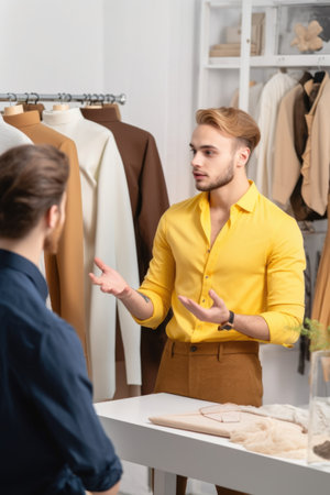 handsome male designer explaining ideas for a new fashion collectionの素材