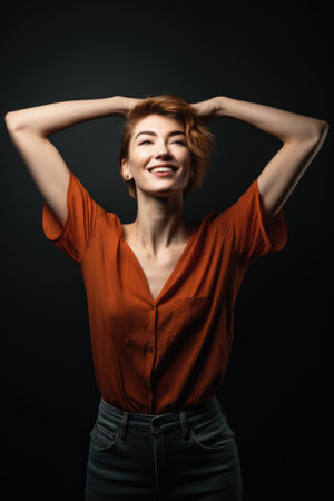 shot of an attractive young woman standing with her arms outstretched against a studio backgroundの素材