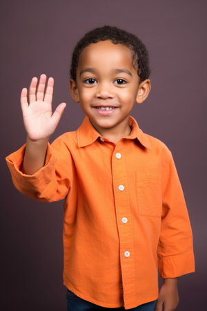 portrait of a cute young ethnic boy holding out his handの素材