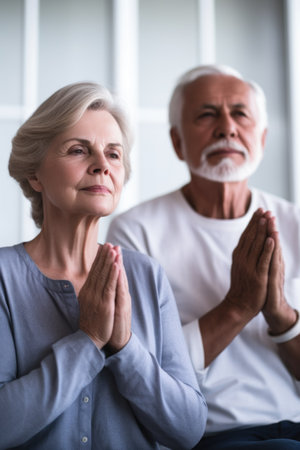 shot of a senior couple meditating at homeの素材