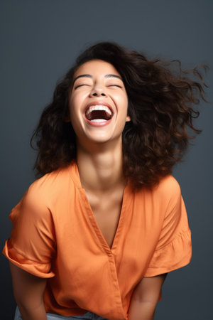 shot of a beautiful young woman looking excited against a studio backgroundの素材