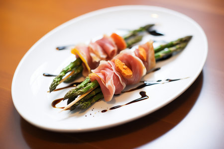 appetizer plate of prosciutto-wrapped asparagus with balsamic glaze drizzleの素材