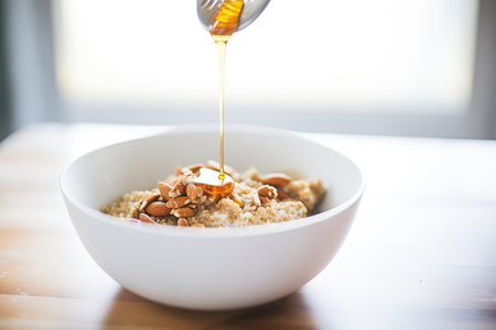 drizzle of almond butter over oatmeal in a white bowlの素材