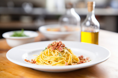 spaghetti carbonara in a deep dish, olive oil bottle in the backgroundの素材