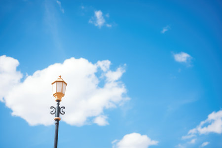 modern lamp post against blue sky backdropの素材